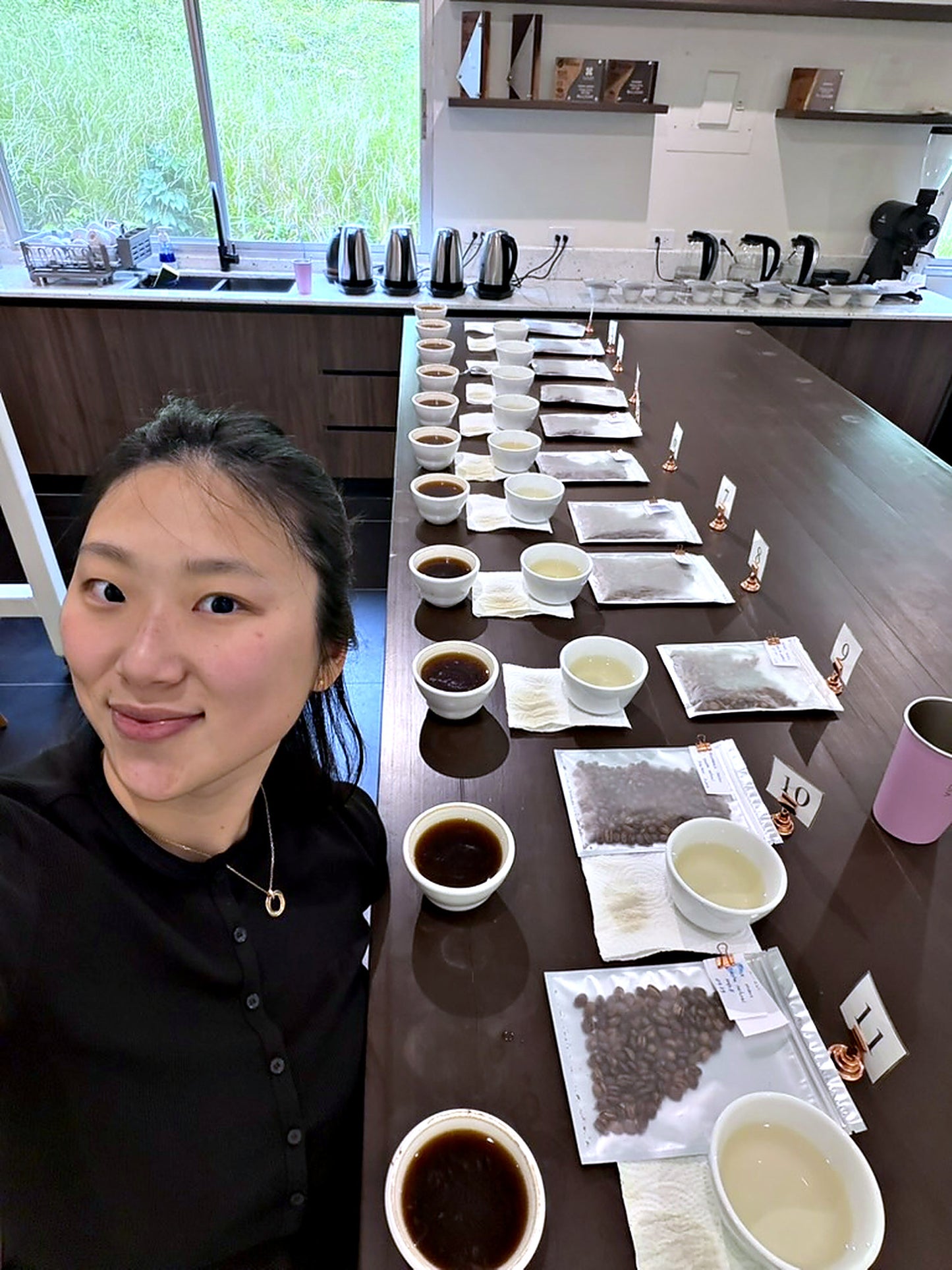 woman smiling in front of many bowls