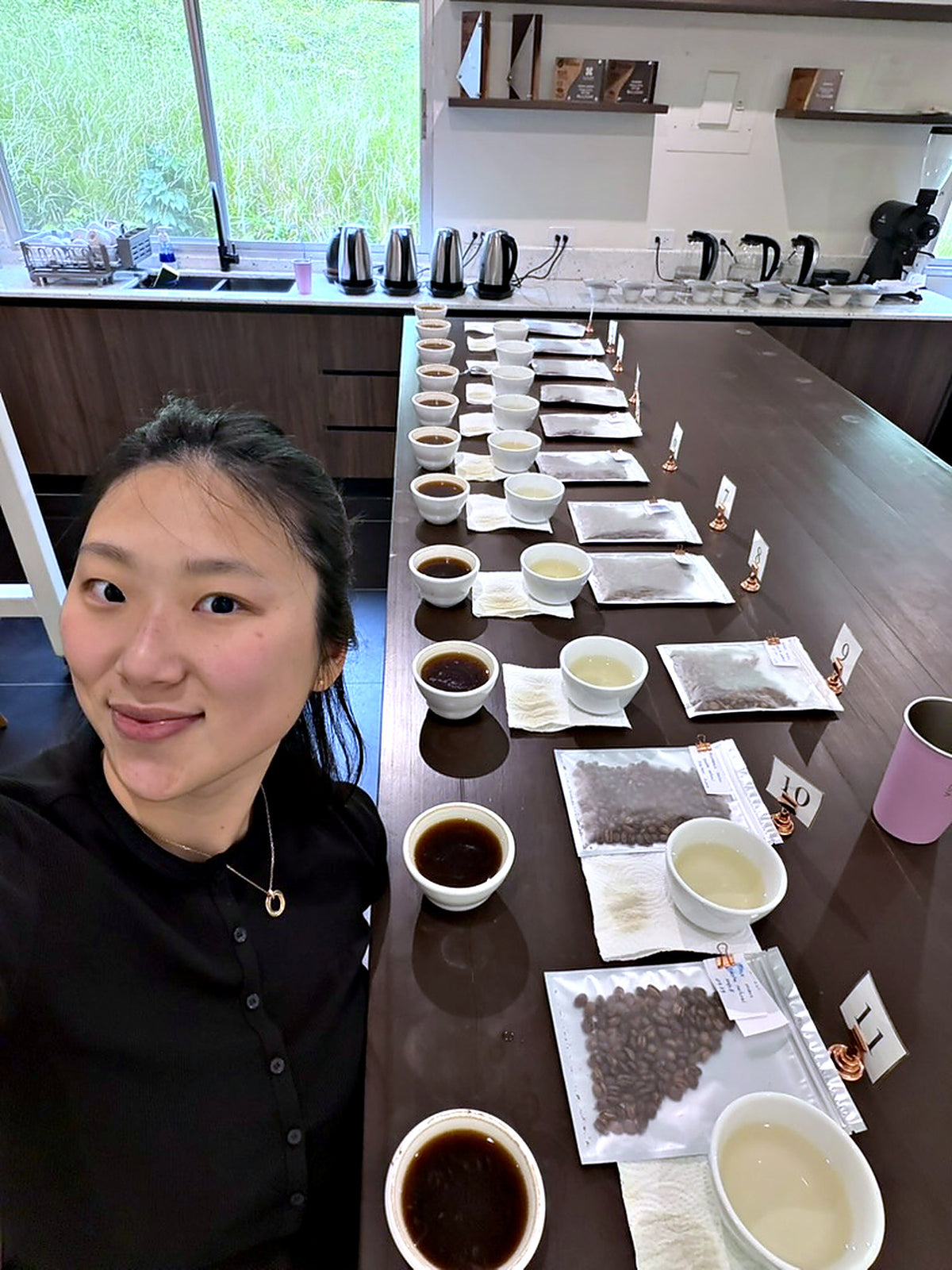 woman smiling in front of many bowls